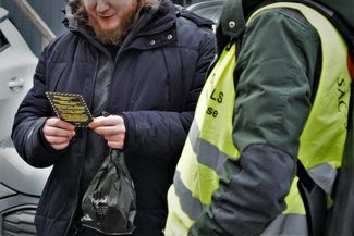 A union member distributes flyers to workers during a blockade