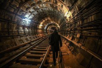 A Kharkiv resident walks from one station to another through a subway tunnel