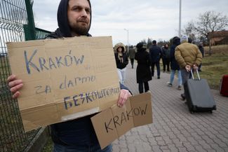 A Ukrainian living in Poland waits to meet fellow countrymen in the town of Medyka, with an offer to transport them to Kraków free of charge. February 25 2022.