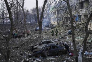 Ukrainian rescue workers outside of the destroyed hospital building in Mariupol. March 9, 2022