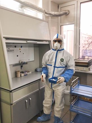 Oncohematologist Islam disinfects his gloves before meeting with each patient.