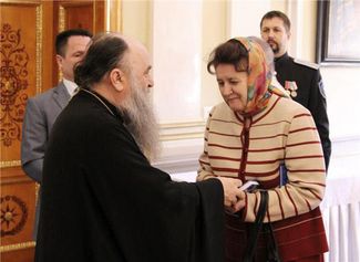 Varsonofi, Metropolitan of St. Petersburg and Ladoga, blesses Lyubov Kachesova for her work as children's rights commissioner. April 25, 2015.