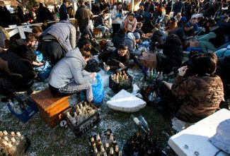 Civilians in Uzhhorod prepare Molotov cocktails to defend the city.