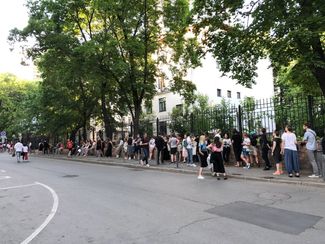 Picketers wait their turn to hold up signs in support of the Khachaturyan sisters. June 2019