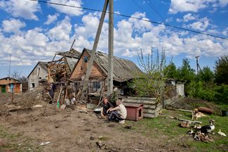 Жители поселка городского типа Золочев (Харьковская область) возле здания, разрушенного российскими обстрелами. По <a href="https://t.me/synegubov/6199" rel="noopener noreferrer" target="_blank">данным</a> местных властей, обе ракеты попали в землю между жилыми домами: пострадавших нет, в зданиях выбило окна, также разрушены два гаража