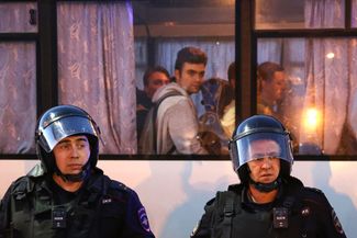 Police outside a vehicle of arrested protesters in Yekaterinburg