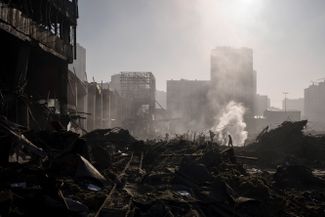 Firefighters try to put out the flames that engulfed Retroville mall in Kyiv’s Podilsky district. The Russian Defense Ministry acknowleged that the shopping center war struck by Russian troops. 