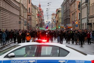 A police car blocking the path of protesters