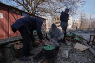 Mariupol residents prepare food over an open fire. March 13, 2022.