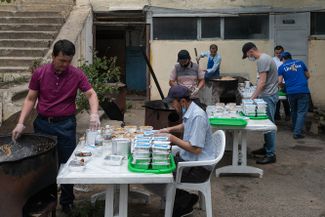 Insan workers and volunteers cook plov that they will later hand out for Uraza-Bairam (known in Arabic as Eid al-Fitr). Makhachkala, Dagestan; May 24, 2020