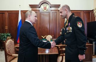 Vladimir Putin meets with DNR Lieutenant Colonel Artem Zhoga on May 9, 2022