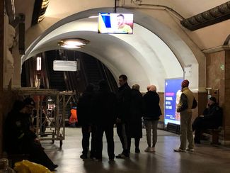 People in the bomb shelter listen to President Volodymyr Zelensky’s address