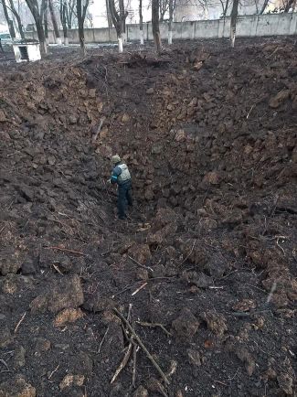 A sapper stands at the bottom of a crater left after an airstrike in Mariupol. March 9, 2022.