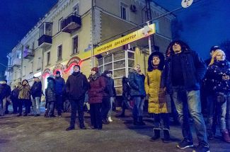 People outside the burning “Winter Cherry” shopping center