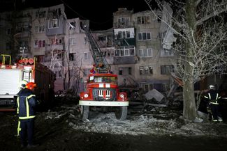 Пожарные возле одной из пятиэтажек, попавших под обстрел