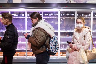 A queue outside a Kyiv grocery store with empty shelves