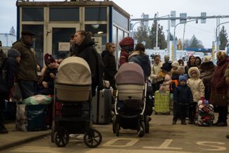 Refugees have their documents checked at the Ukrainian-Slovakian border, not far from the village of Vyšné Nemecké. February 25, 2022.