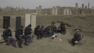 Nurmagomed Gadzhimagomedov’s male relatives pray together at his graveside