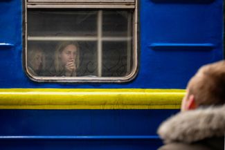 41-year-old Bogdan says goodbye to his wife, Lena, before she leaves for Lviv from a Ukrainian train station. Bogdan will stay to fight in the war while his family tries to leave the country and seek asylum abroad. March 3, 2022