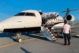 Still unconscious, Navalny is loaded into an ambulance plane in Omsk to be transferred to a clinic in Berlin. August 22, 2020.