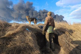 Smoke from an oil storage facility damaged by artillery fire.