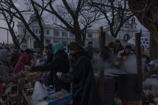 Volunteers hand out food at the Lviv train station