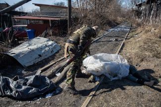 A Ukrainian soldier and the body of a Russian soldier. March 10, 2022