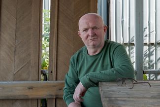 Leonid Gonin sits in the courtyard of the Udmurt Institute of History, Language, and Literature. September 2019