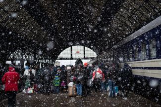 Refugees at a rail station in Lviv (365 miles east of Kyiv), waiting for trains to reach Poland.